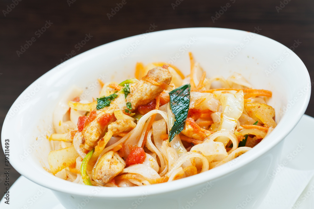 Spicy swordfish pieces with noodles and spring onions Spicy swordfish pieces with noodles and spring onions