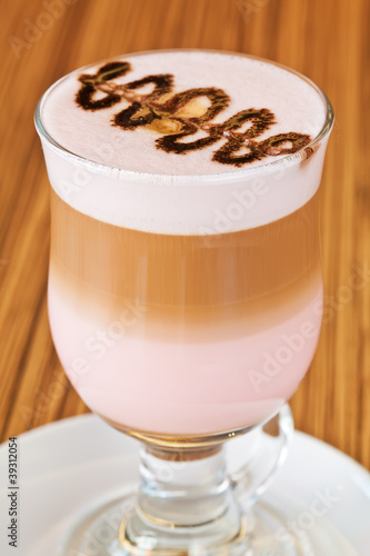 Chocolate decoration on the glass of latte machiato coffee