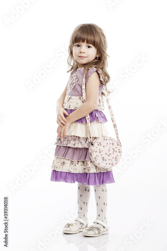 Portrait of a cheerful little girl with a bag