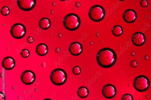 Water drops on red glass