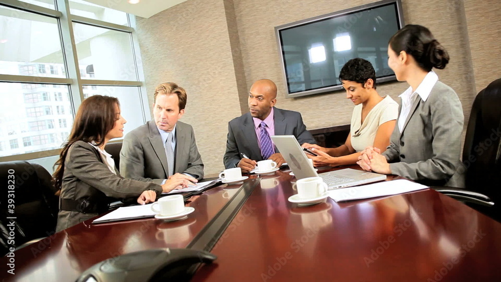 Multi Ethnic Business Team Meeting in Boardroom Multi Ethnic Business Team Meeting in Boardroom