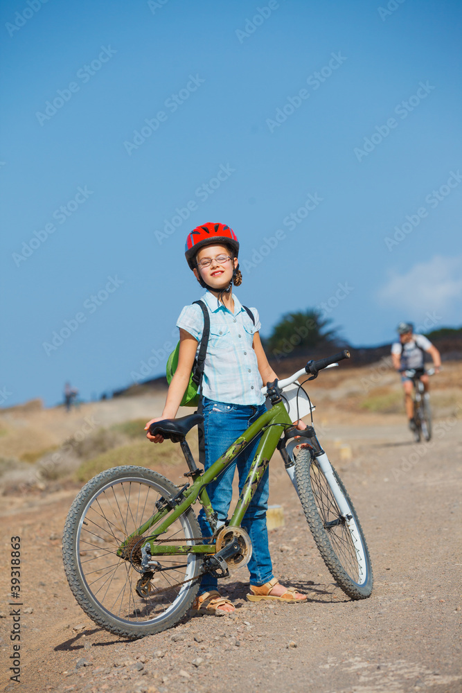 Teenager girl over a bicycle and looking the view