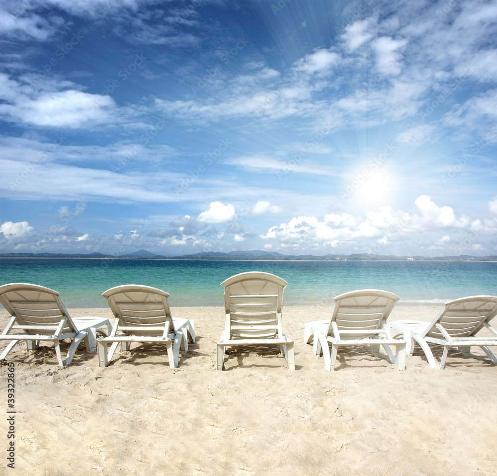 chairs on beach with blue sky for summer holiday