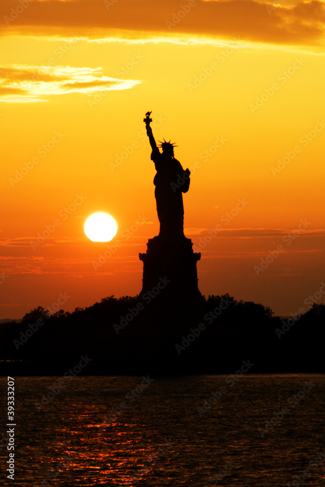 Statue of Liberty silhouette at sunset Statue of Liberty silhouette at sunset