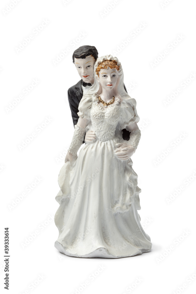 Old plaster bride and groom cake topper isolated on white back Old plaster bride and groom cake topper isolated on white back