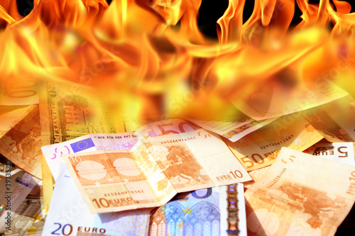 an image of  dollar and euro bills on fire
