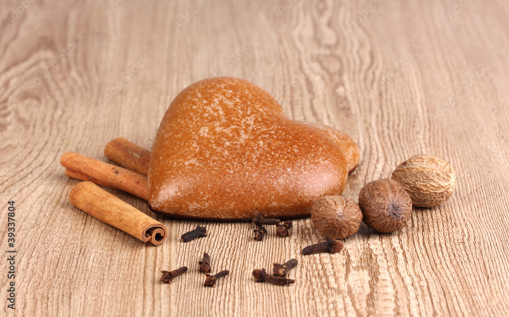 Heart-shaped cookies with cinnamon, nutmegs and carnation