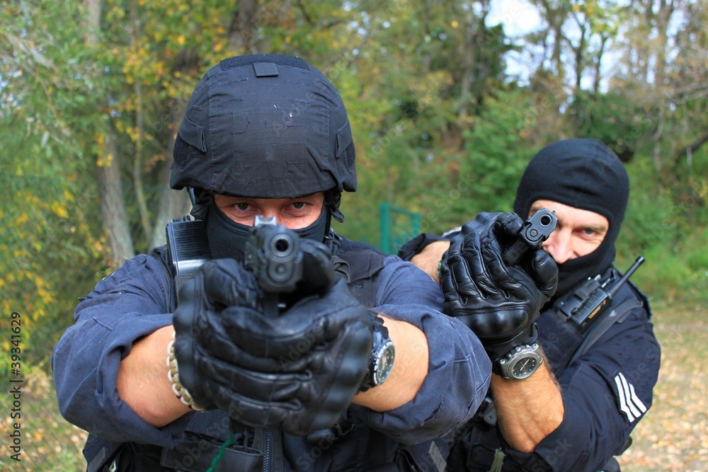 Fototapeta premium two armed policemen, aiming frontal view details