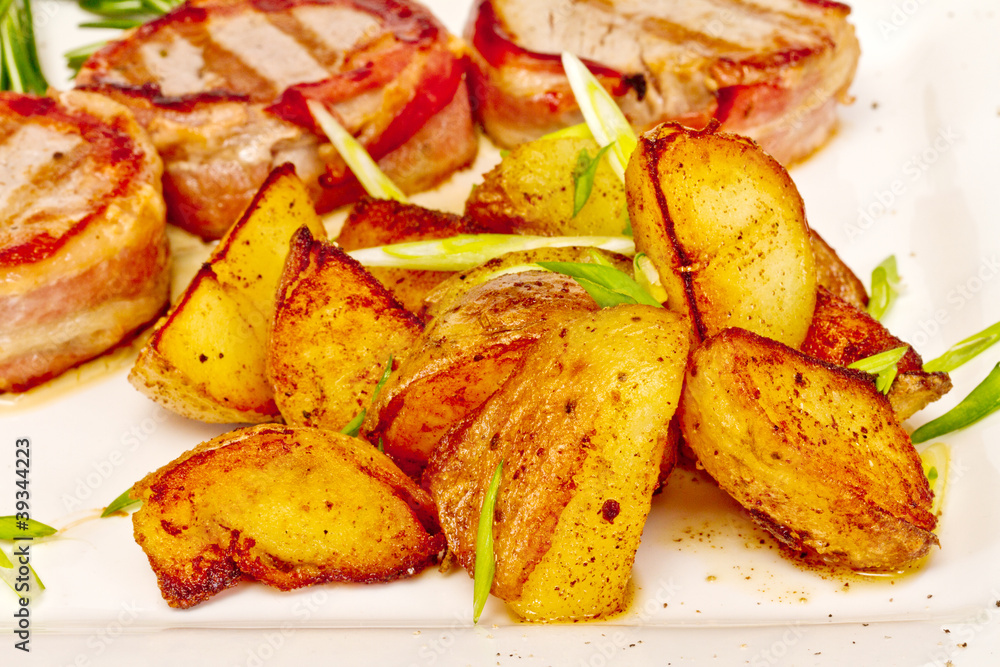 Grilled steak wrapped in bacon, with grilled vegetables Grilled steak wrapped in bacon, with grilled vegetables