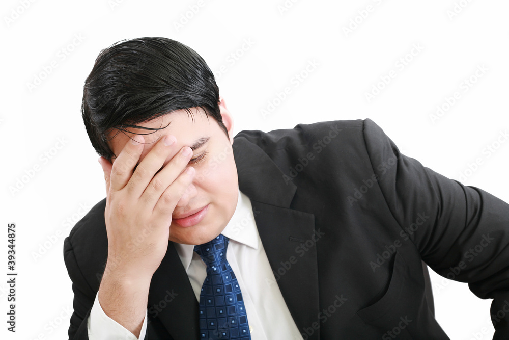 Portrait of a young business man depressed from work against whi Portrait of a young business man depressed from work against whi