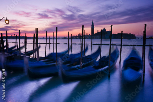 Gondolas moored by Saint Mark's square at dawn in Venice © ErickN