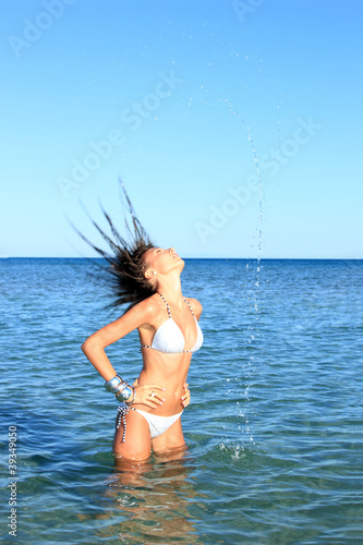 Sexy bikini model having fun in the ocean