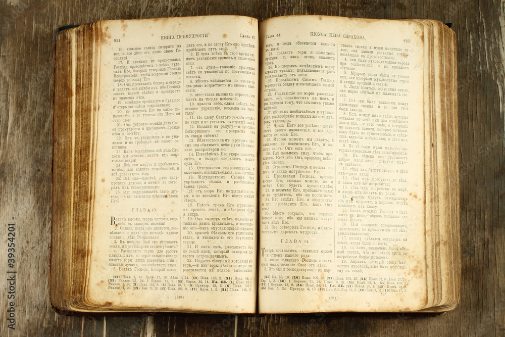 Obraz premium Open old Bible on wooden background