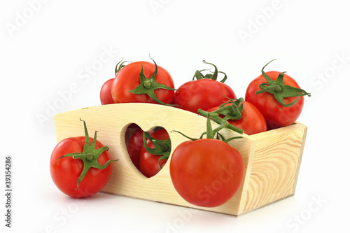 Wooden box full of tomatoes