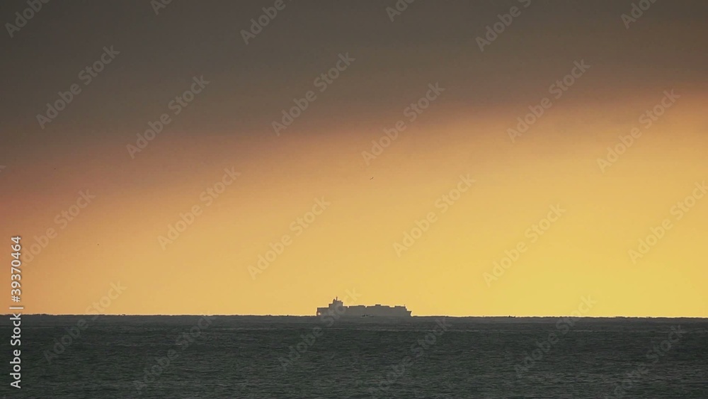 Cargo ship and sea at sunset Cargo ship and sea at sunset