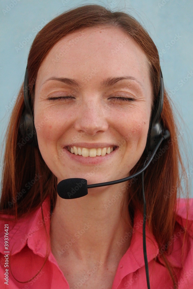 Redhead young woman at helpdesk center, smiling Redhead young woman at helpdesk center, smiling