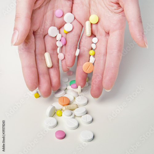 Woman hands with different medicines on white background