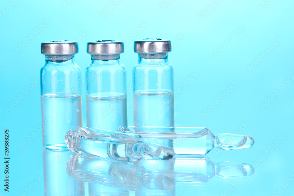 Medical ampoules on blue background Medical ampoules on blue background