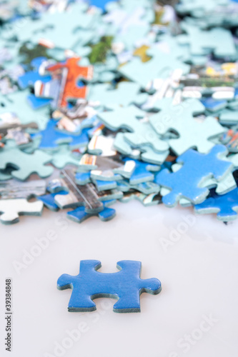Pieces of puzzle spilled on table