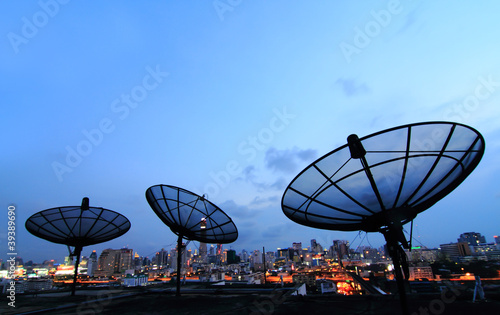 black antenna communication satellite dish over sunset sky in ci