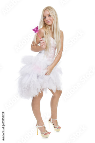 Beautiful smiling blond girl with magic wand isolated on white b