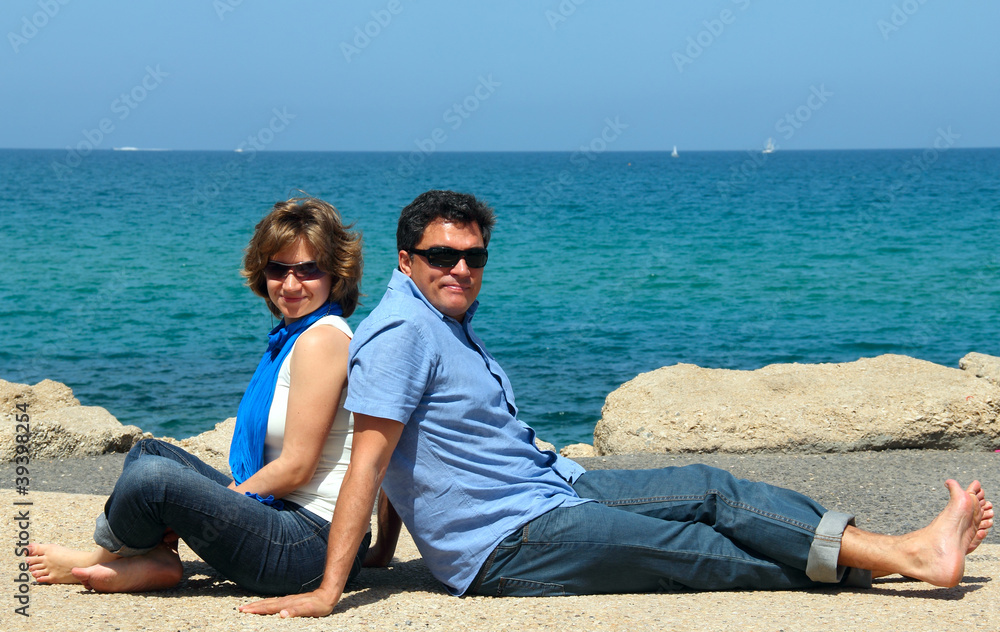 portrait of a happy family on the background of the sea