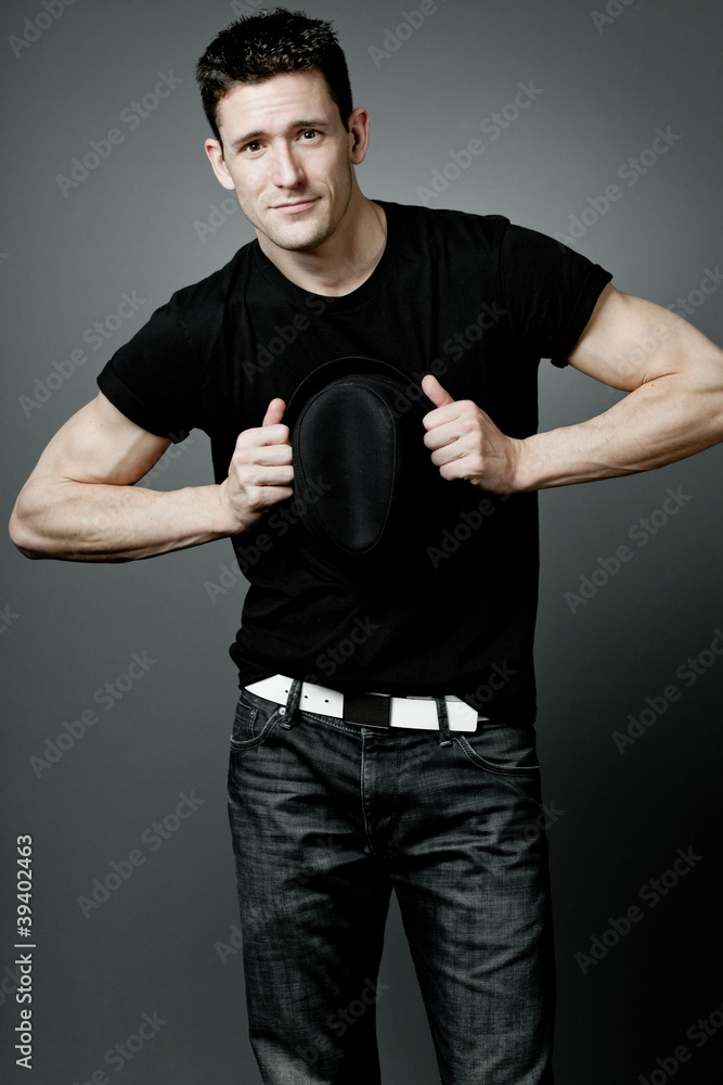 Handsome man posing in black t-shirt and black hat. Handsome man posing in black t-shirt and black hat.