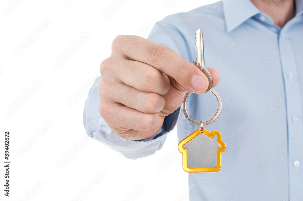 hand holding house key hand holding house key