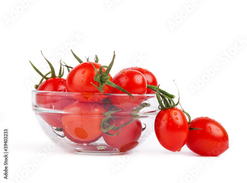 fresh tomatoes with green leaf in plate isolated on white backgr