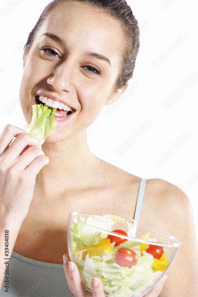 Woman eating salad. Portrait of beautiful smiling and happy woma Woman eating salad. Portrait of beautiful smiling and happy woma
