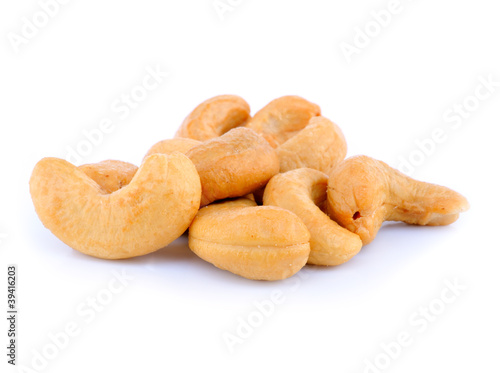 Pile of roasted cashew nuts in isolated white background