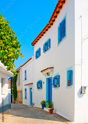 Old house with blue doors and windows in Skiathos Greece