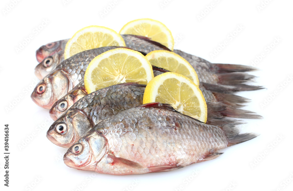 Fresh fishes with lemon isolated on white