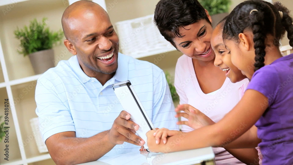 Young Parents Watching Children Using Wireless Tablet Young Parents Watching Children Using Wireless Tablet
