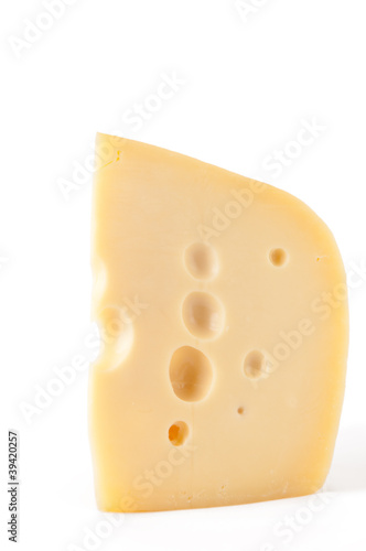 Piece of Maasdam cheese, white background