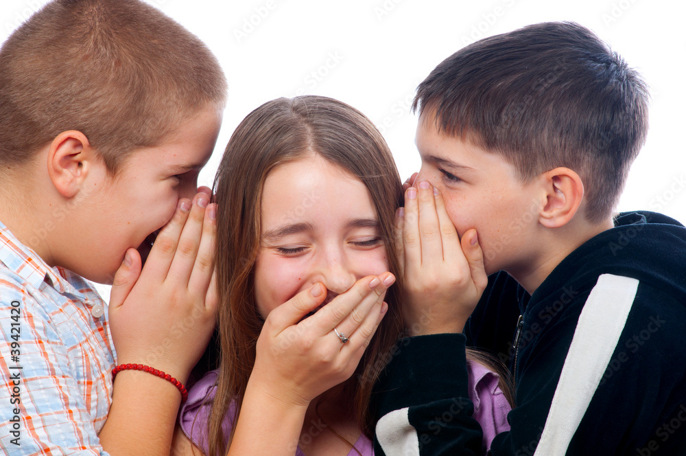 Two teenage boys telling jokes to teenage girl Two teenage boys telling jokes to teenage girl