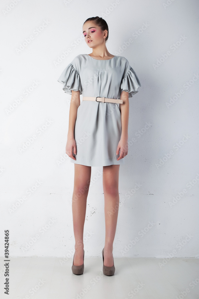 Young tranquil fashion woman in light blue dress posing Young tranquil fashion woman in light blue dress posing