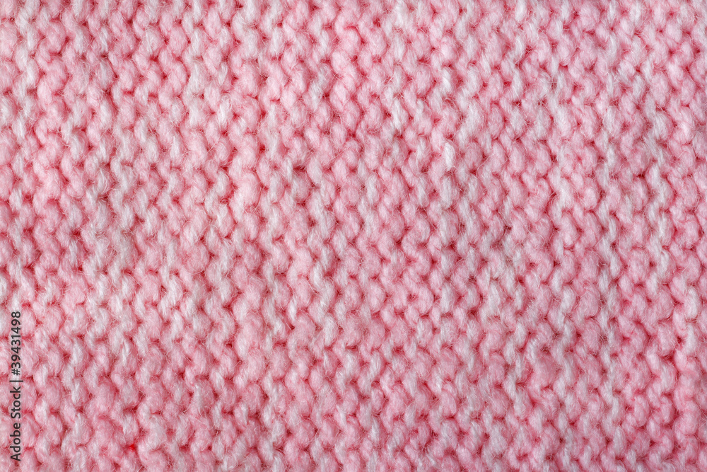 Pink color wool knitted background closeup Pink color wool knitted background closeup