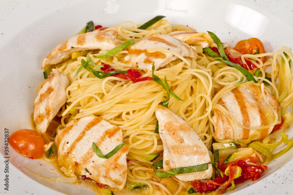 close-up of plate of pasta and chicken close-up of plate of pasta and chicken