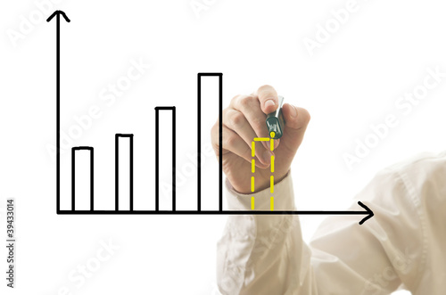 Businessman drawing bar graph with prediction of crisis photo