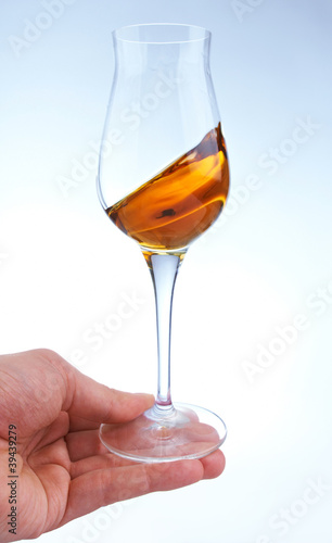 glass of brandy or whisky in the hand