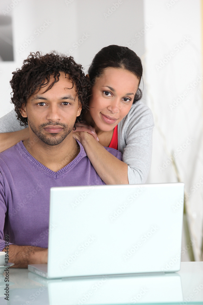 Mixed-race couple at laptop