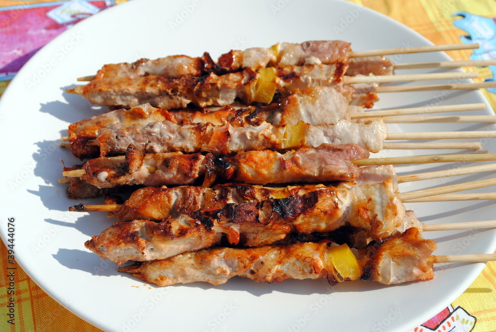 cocked pork kabobs grilled on skewers in a plate