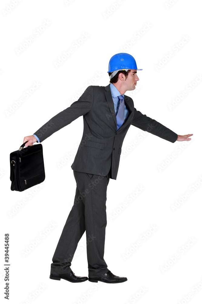 foreman in suit holding briefcase foreman in suit holding briefcase