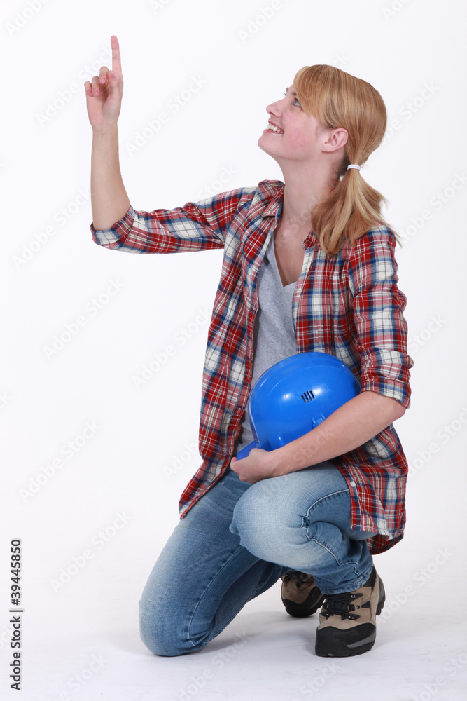 craftswoman pointing and looking up