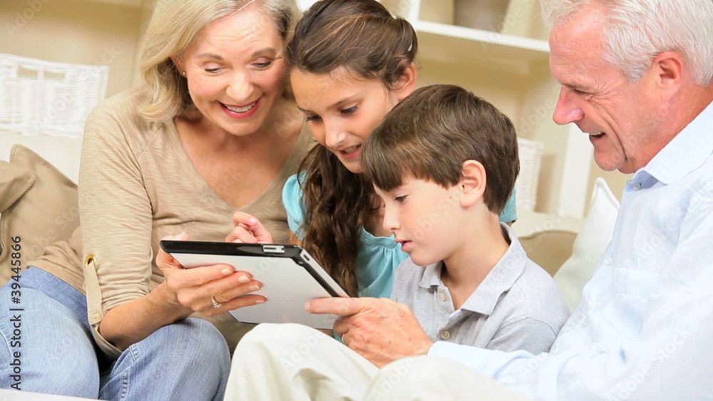 Children and Grandparents Using Wireless Tablet Children and Grandparents Using Wireless Tablet