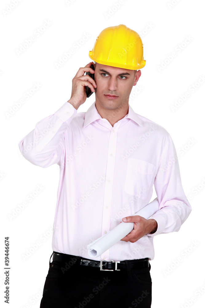businessman wearing helmet and talking on the phone