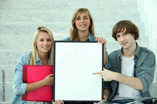 Students pointing at white board