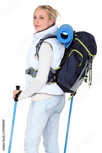 Female walker with poles and a backpack