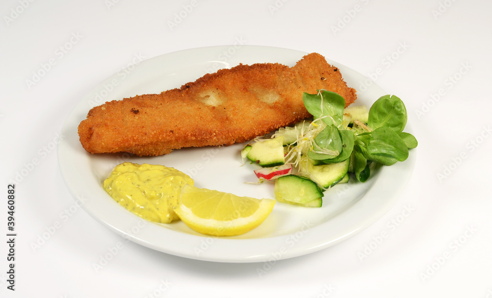 Fish with lemon and salad on a white context. Fish with lemon and salad on a white context.